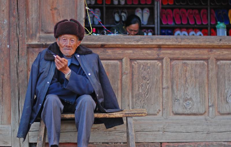 An old man sitting on the bench. Image Credit: Flickr / timquijano